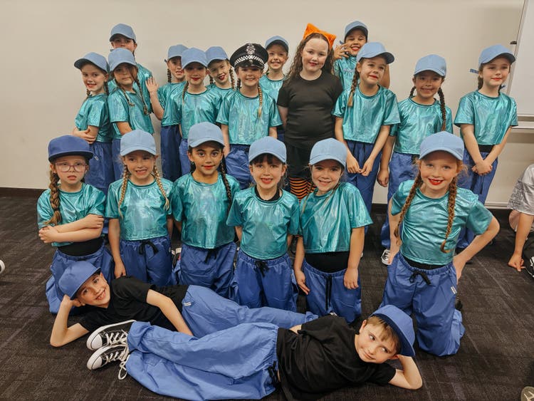 Our K-2 dance group in their aqua shirts, blue shirts and blue caps.